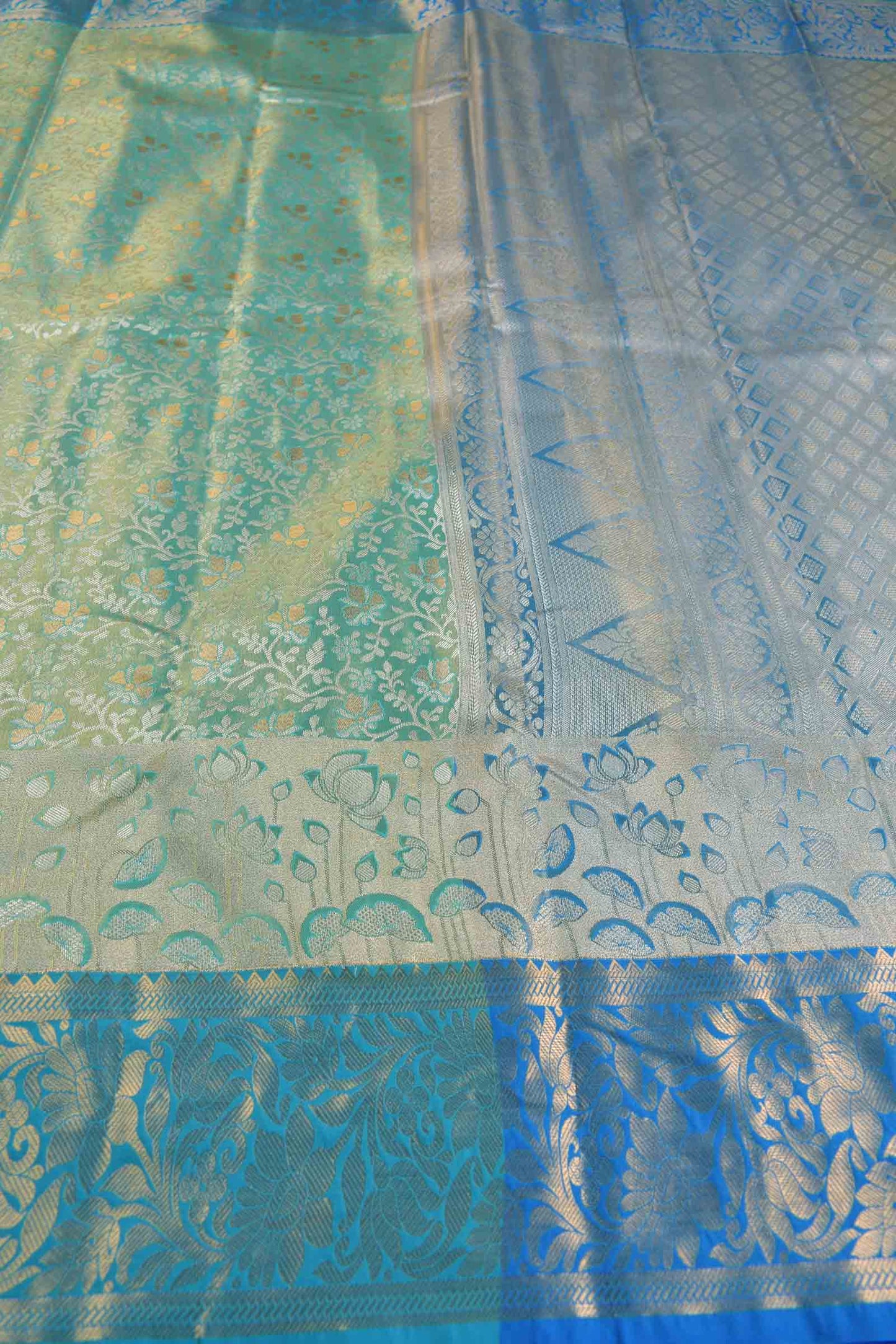 Golden Light Green Semi Silk All Over Florals Golden Blue Border Saree