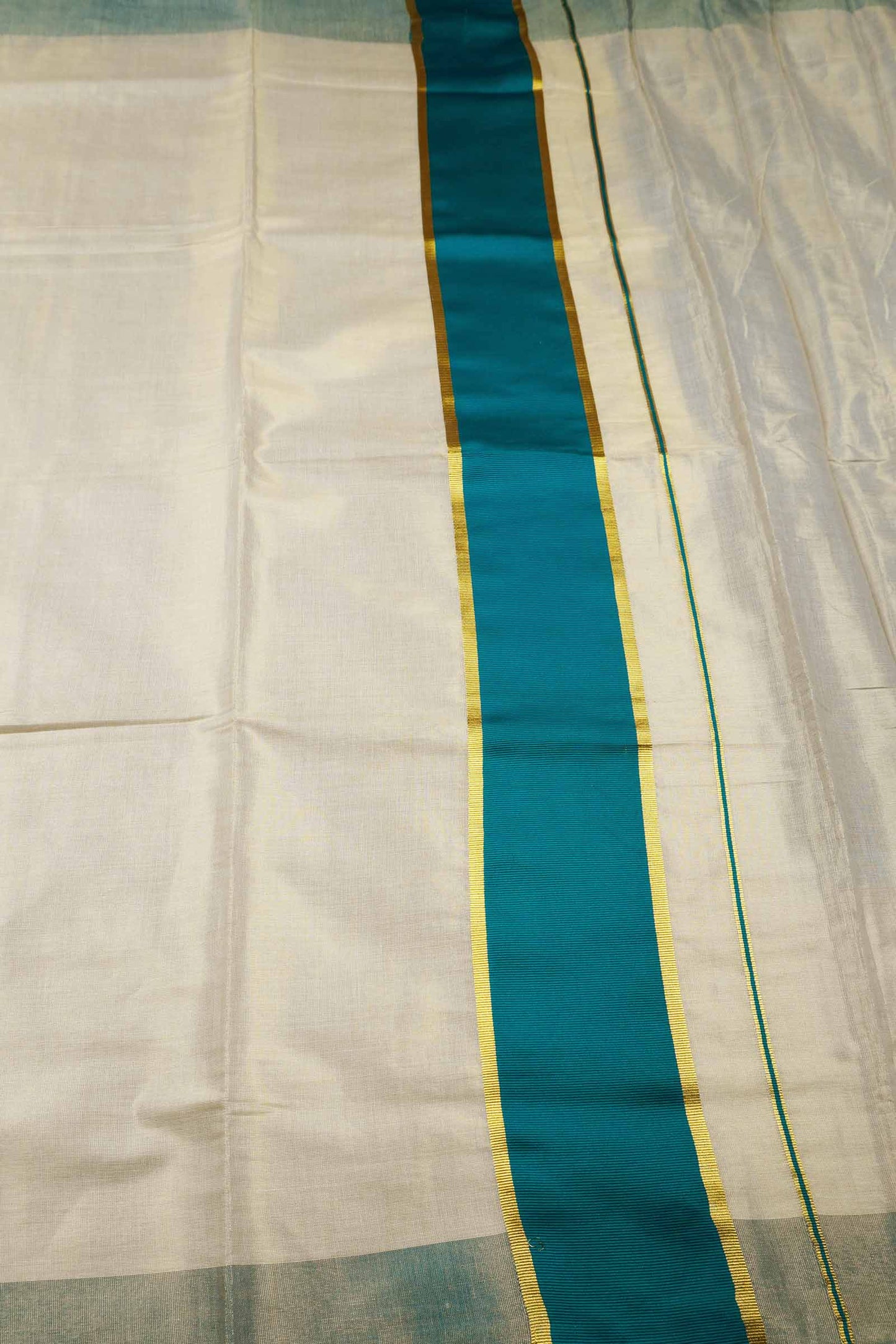 Off White With Peacock Blue Kerala Tissue Cotton Golden Zari Line Saree