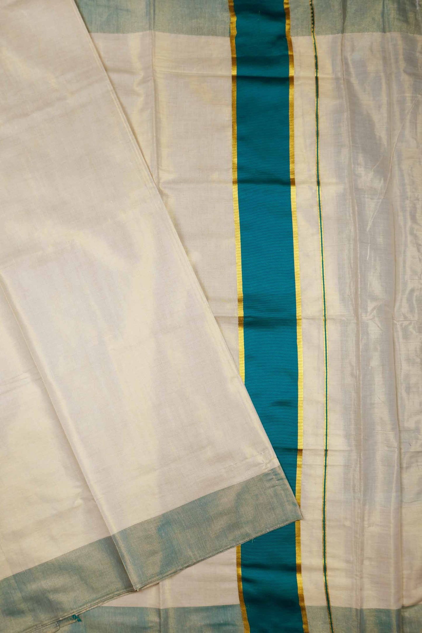 Off White With Peacock Blue Kerala Tissue Cotton Golden Zari Line Saree