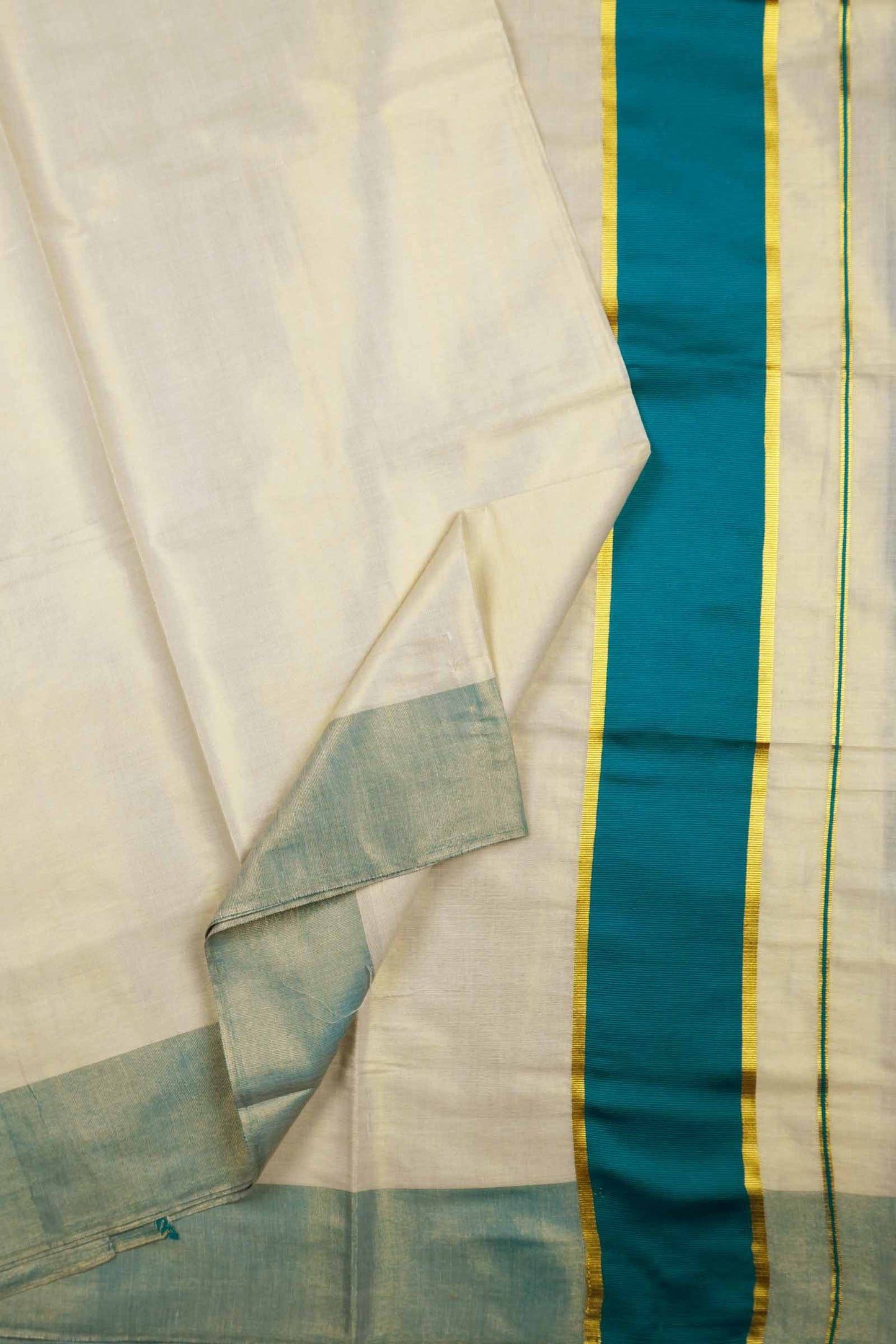 Off White With Peacock Blue Kerala Tissue Cotton Golden Zari Line Saree