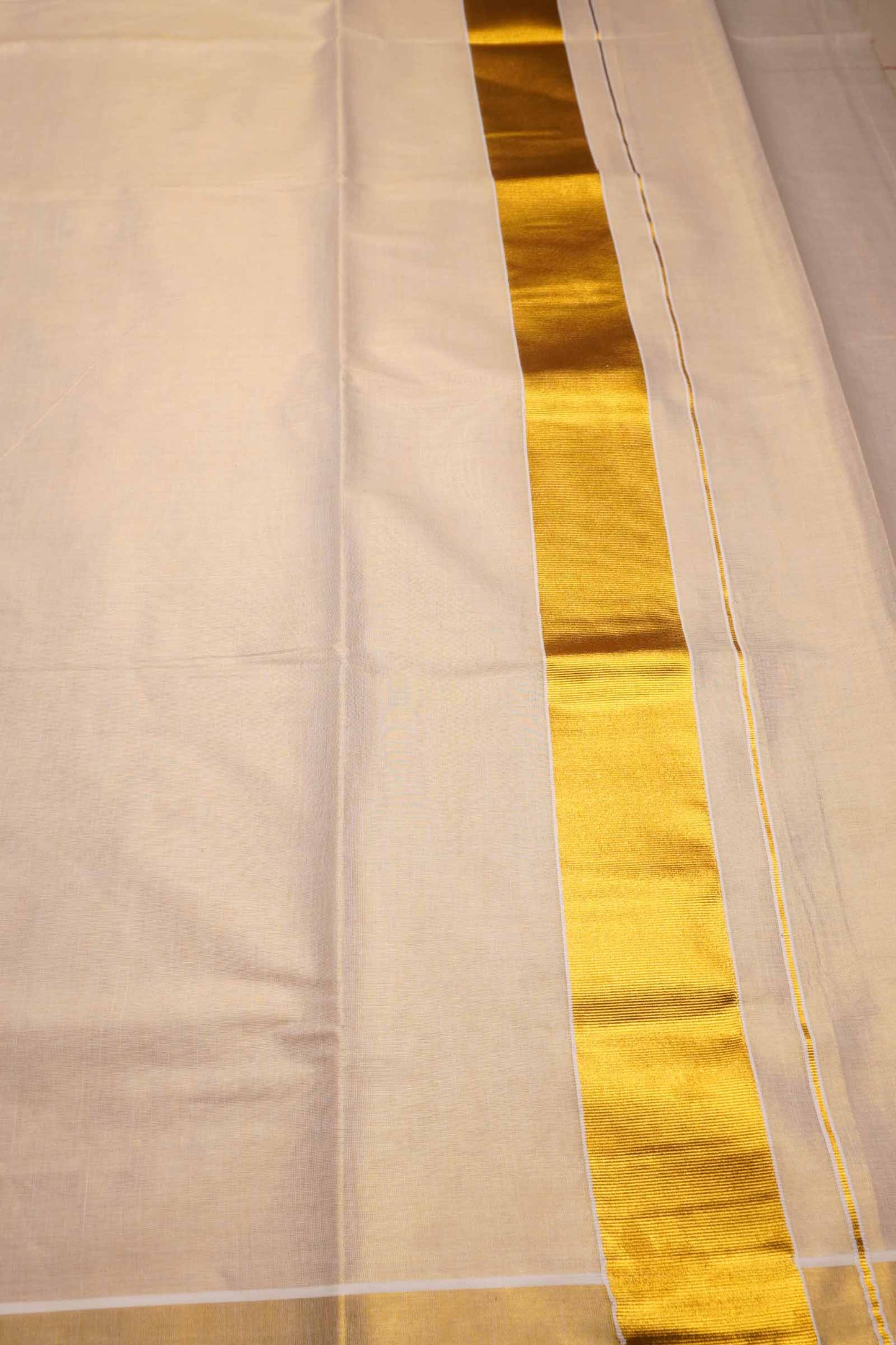 Off White Kerala Tissue Minimalistic Plain Body Golden Zari Border Saree