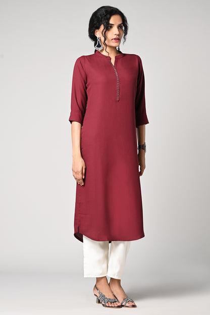 solid plain maroon kurti.
closed neck with v cut.
bead work in neck line.
3/4 attached sleeves.